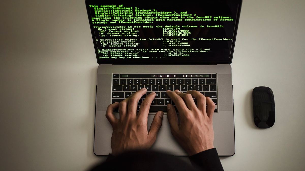 Developer writing code on a laptop