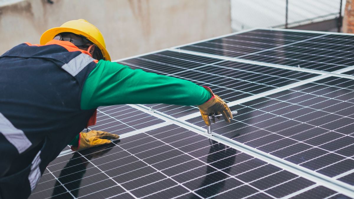 Technician installing solar panels